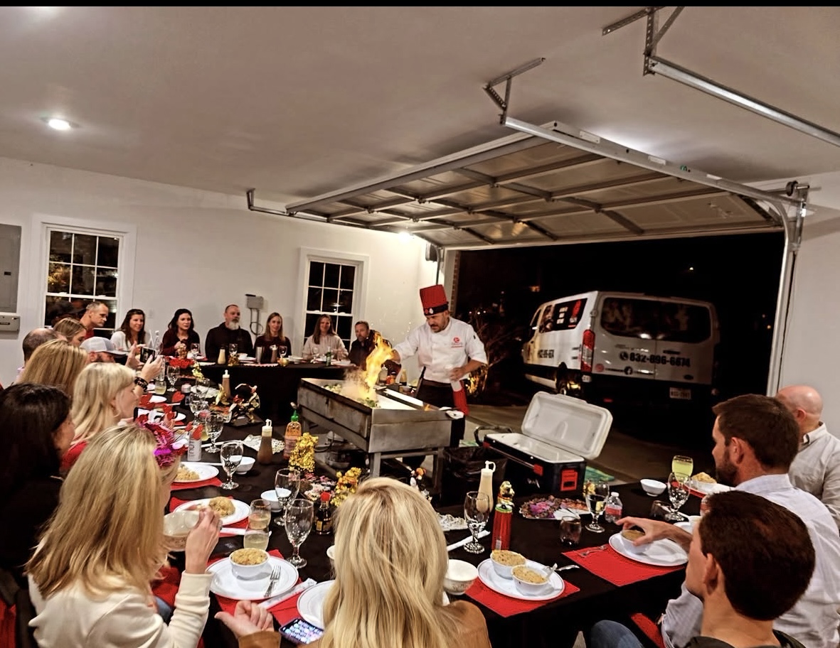 Guests gathered around a hibachi chef